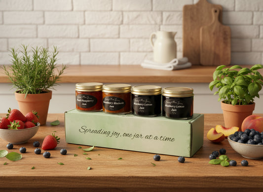 Four jars of berry jam on a box with text 'Spreading joy, one jar at a time' on a marble surface.